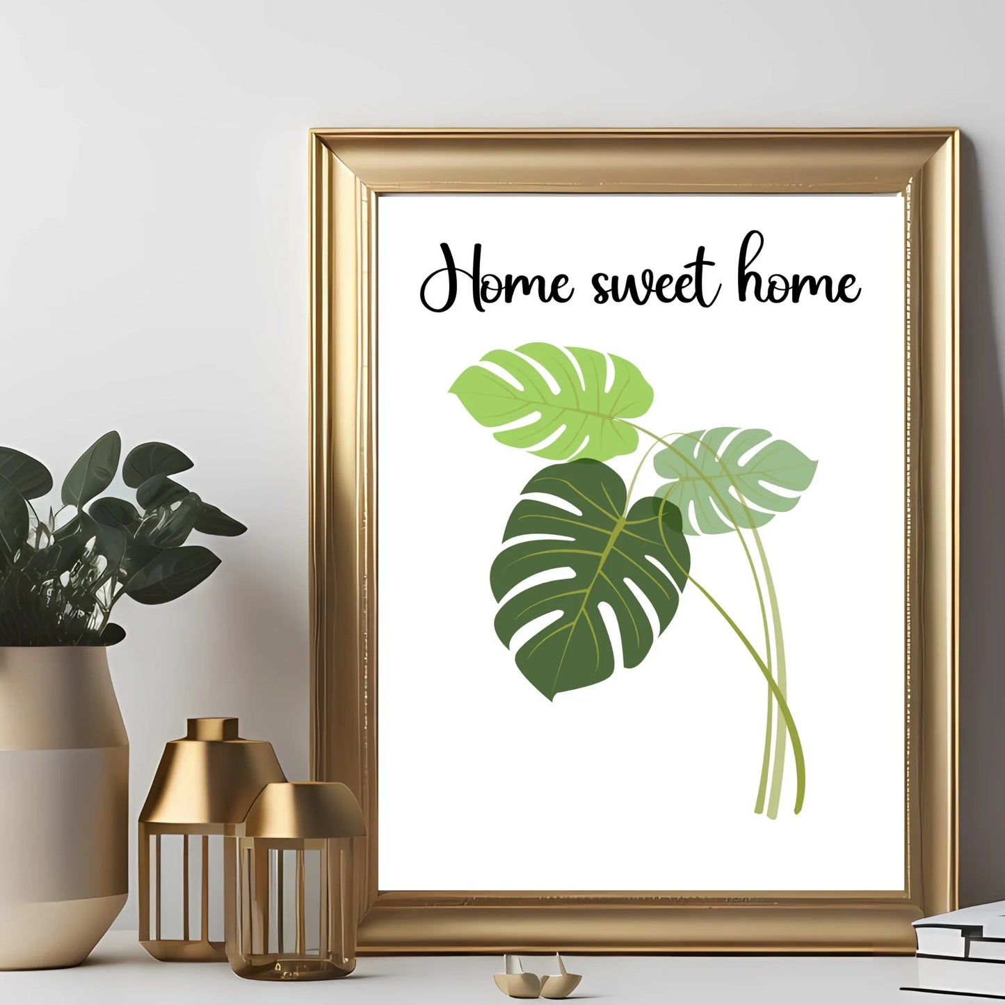 Gold frame wall art with 'Home sweet home' text and monstera leaves, modern decor setting