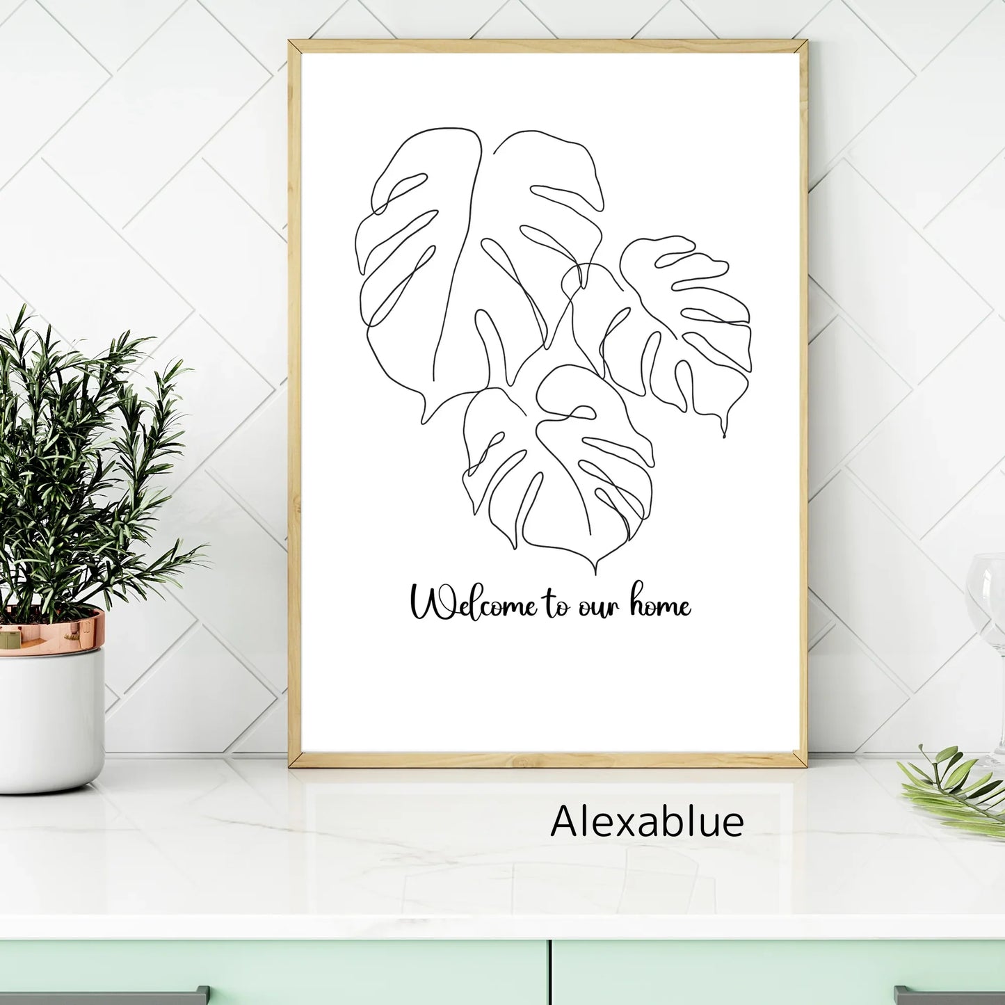Minimalist Monstera leaf line art print with 'Welcome to our home' in modern kitchen decor