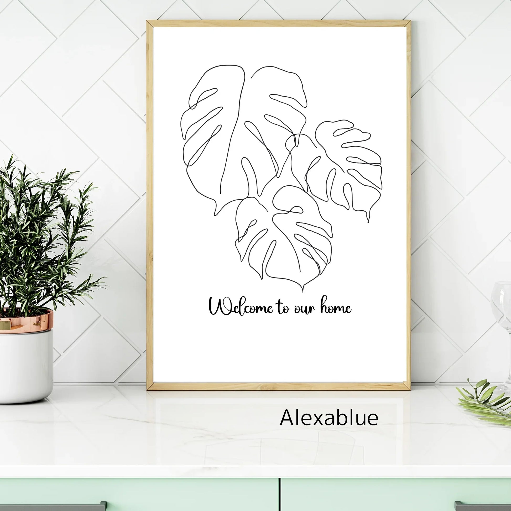 Minimalist Monstera leaf line art print with 'Welcome to our home' in modern kitchen decor