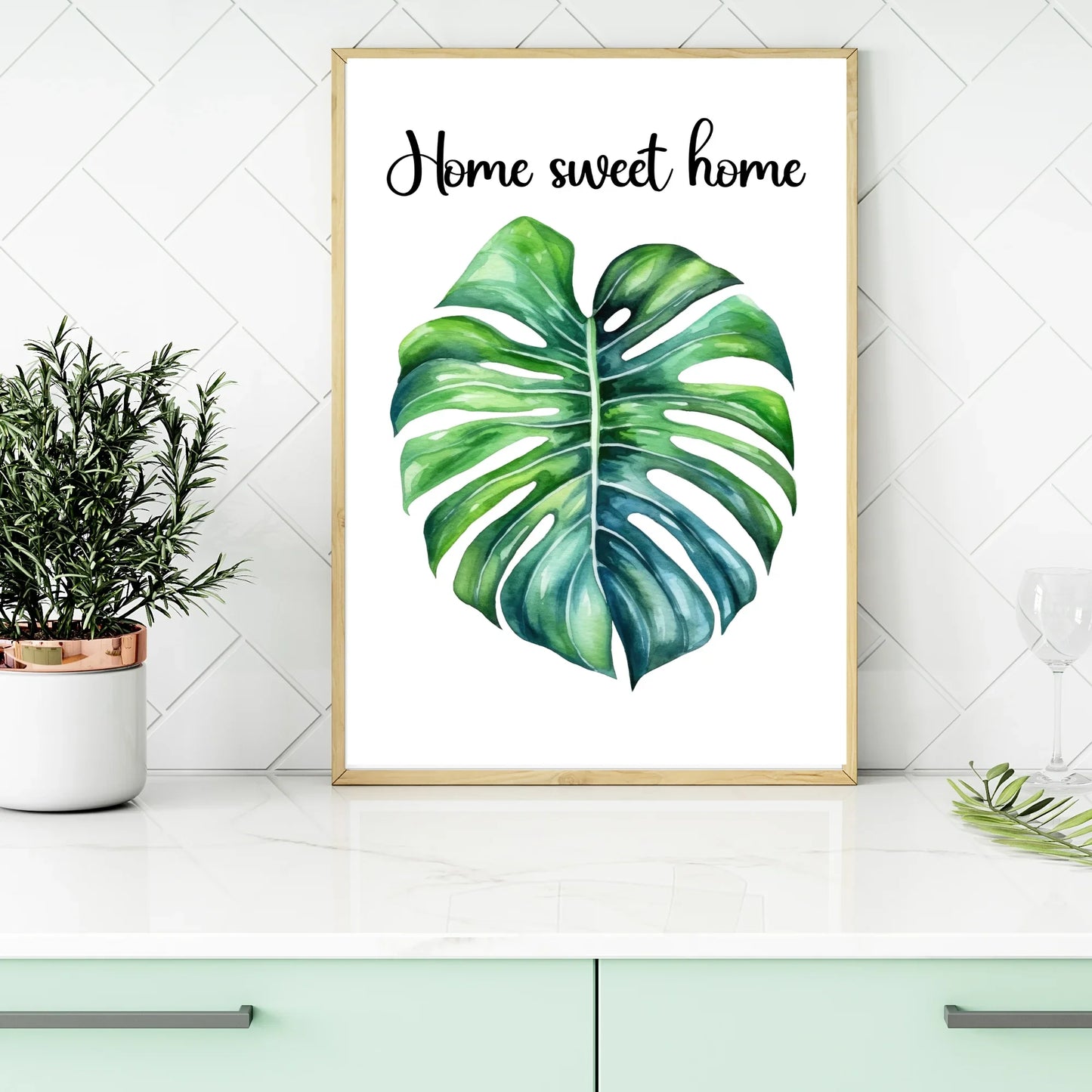 Framed monstera leaf wall art with 'Home sweet home' text, modern kitchen decor