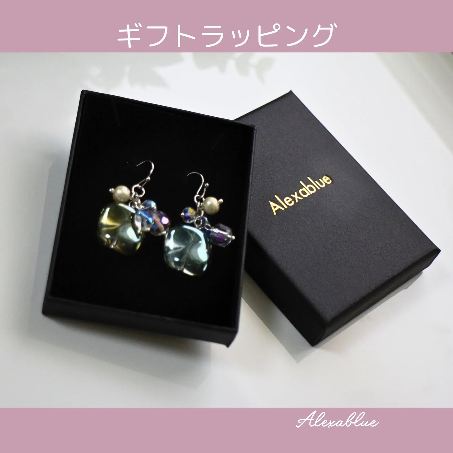 Gift-wrapped natural stone earrings with pearls and crystals in a black jewelry box