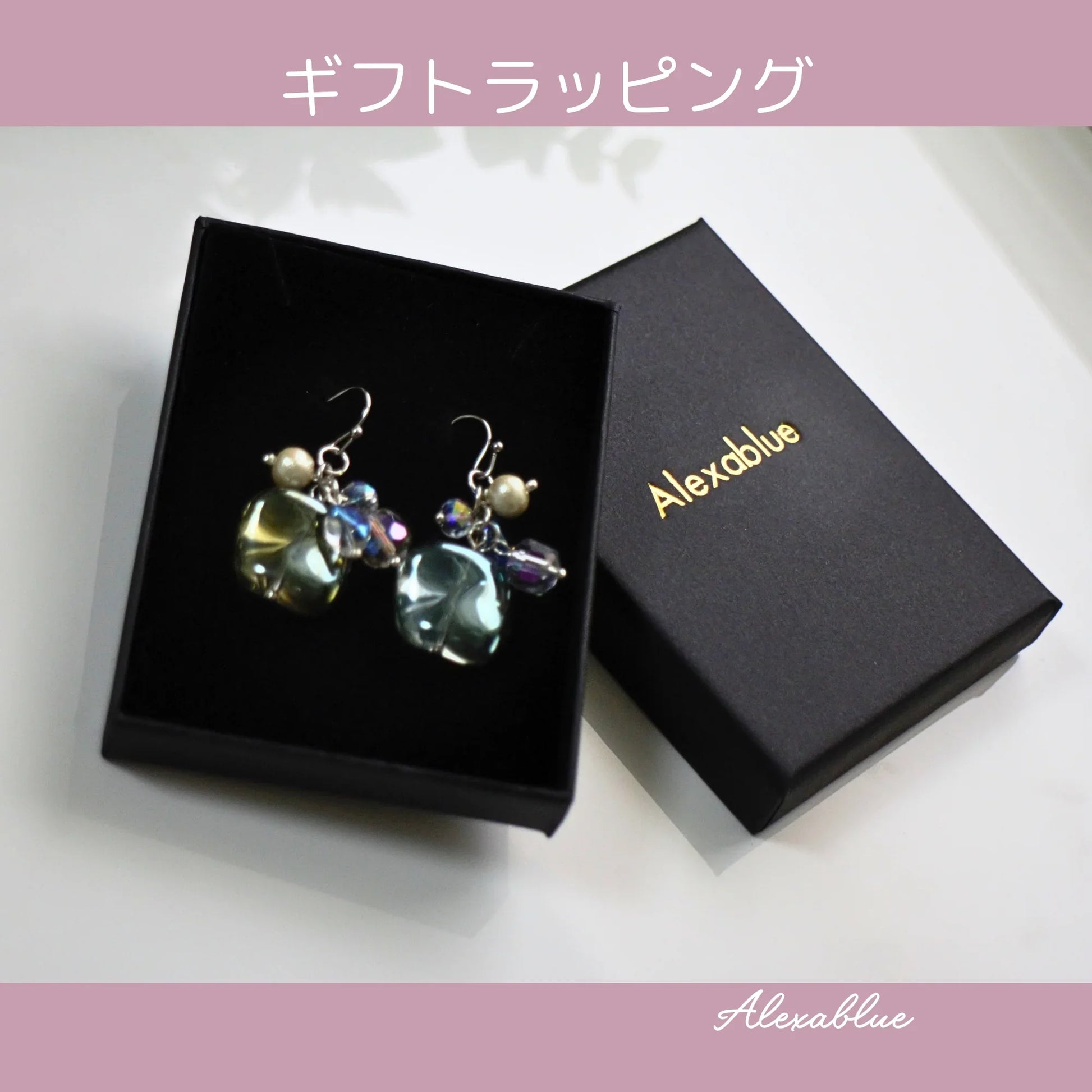 Natural stone dangle earrings with crystal beads in a black gift box, elegant jewelry packaging.