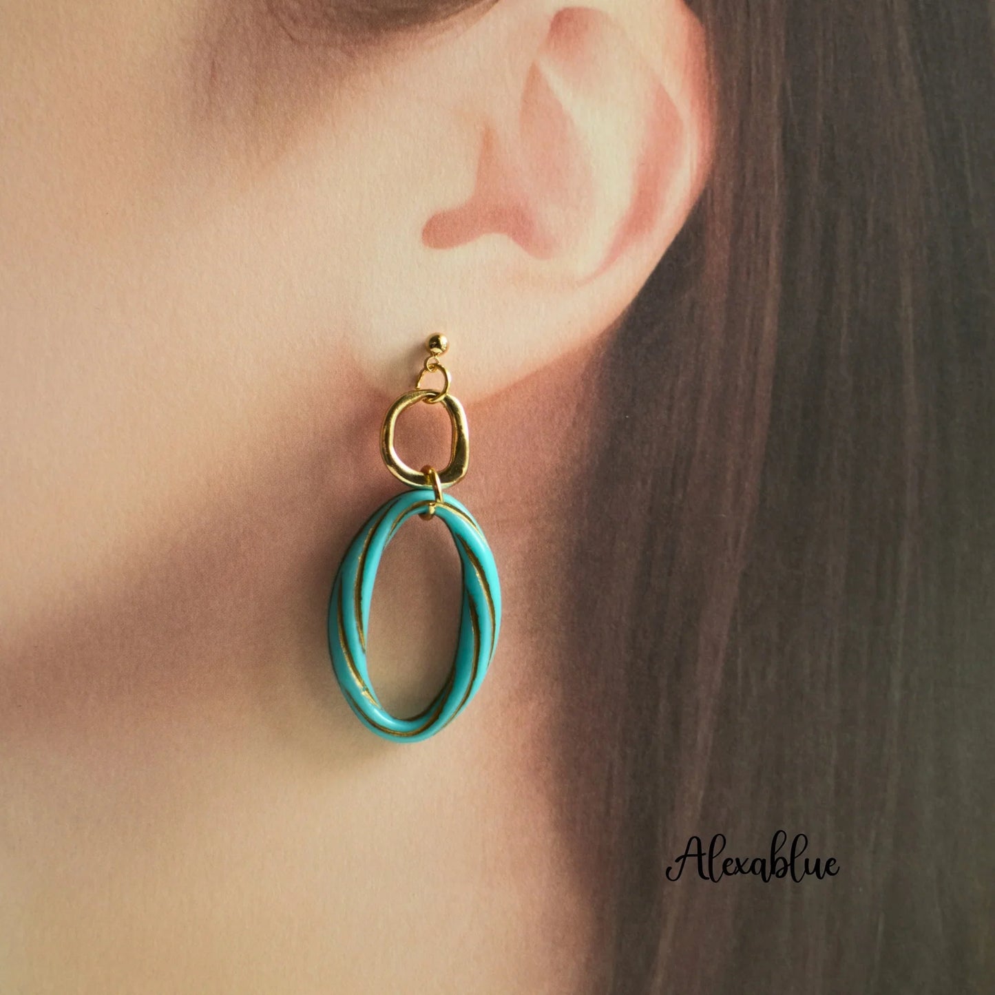 Gold and turquoise oval statement earring worn on ear, natural stone jewelry style