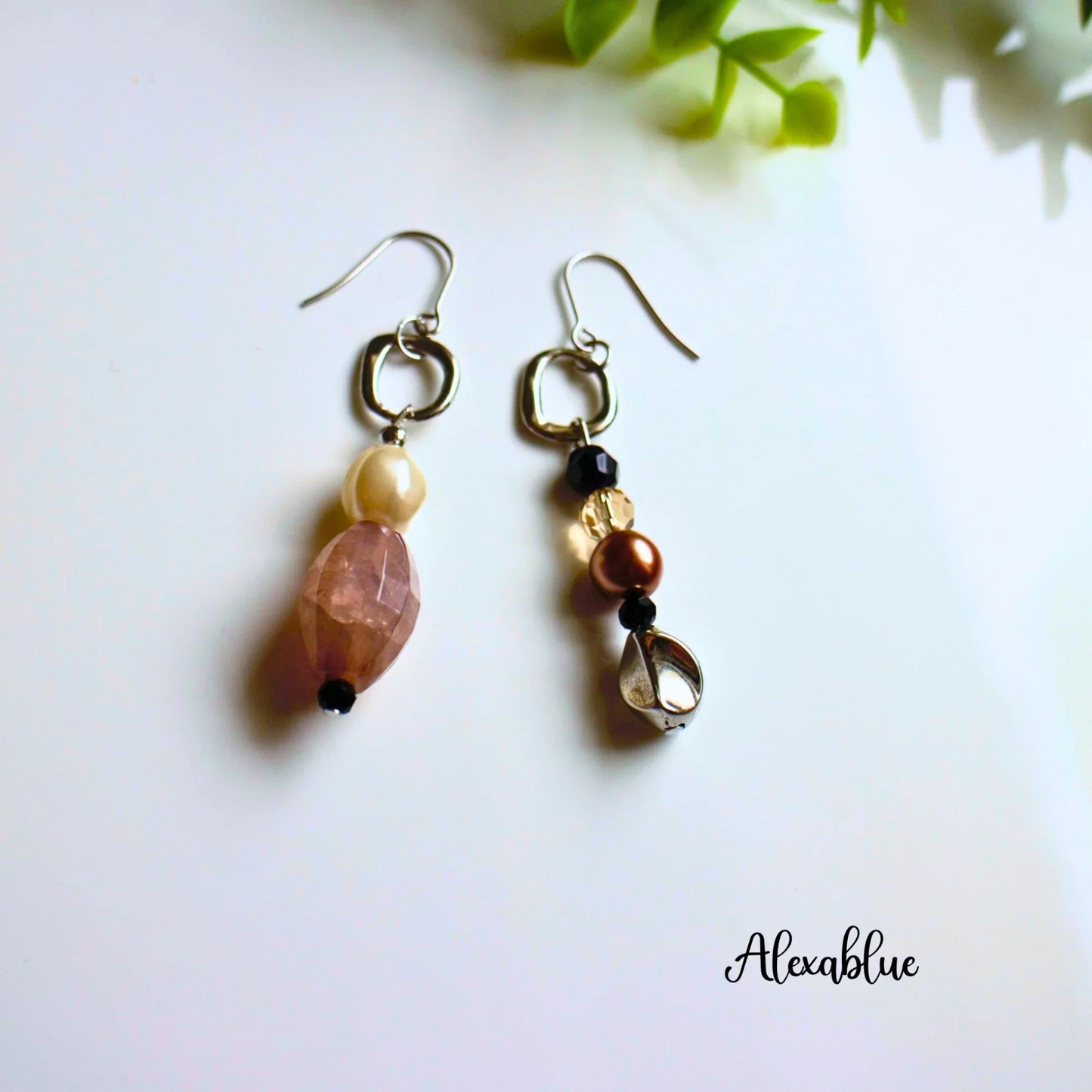 Asymmetrical natural stone dangle earrings with pearls and metallic accents on white background