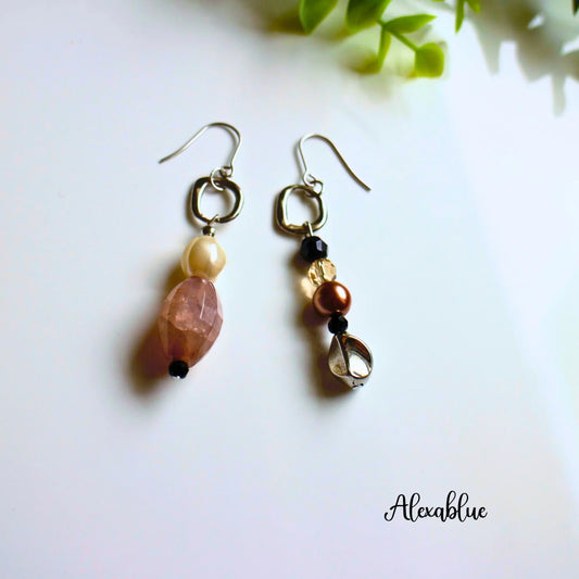 Asymmetrical natural stone dangle earrings with pearls and metallic accents on white background