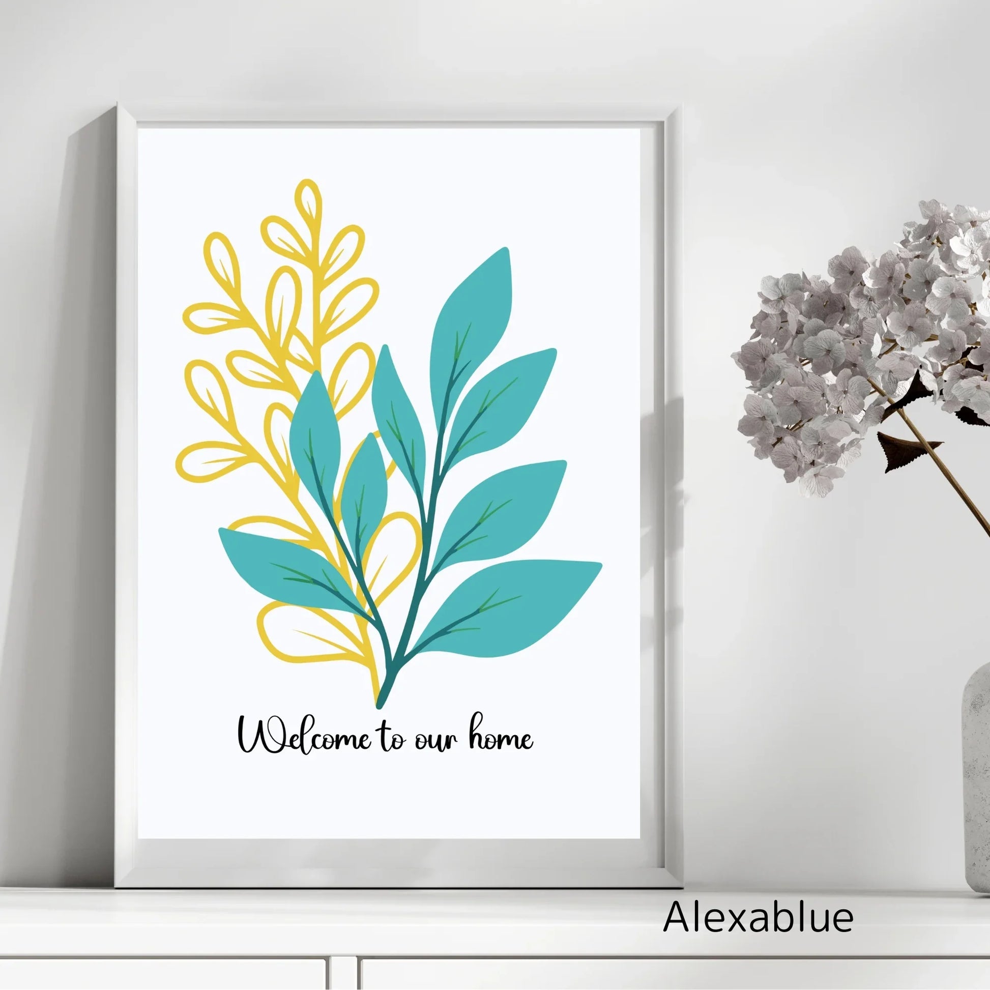 Framed botanical wall art with teal and yellow leaves, 'Welcome to our home' text, and vase of flowers.
