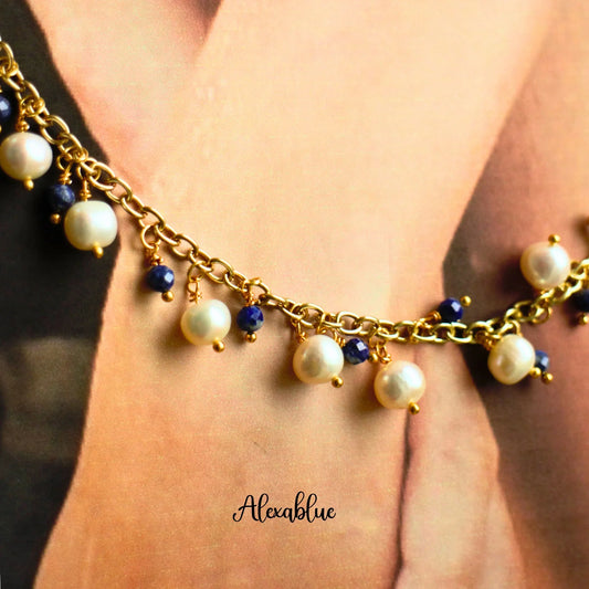 Gold chain bracelet with natural pearls and blue gemstone beads, elegant jewelry close-up