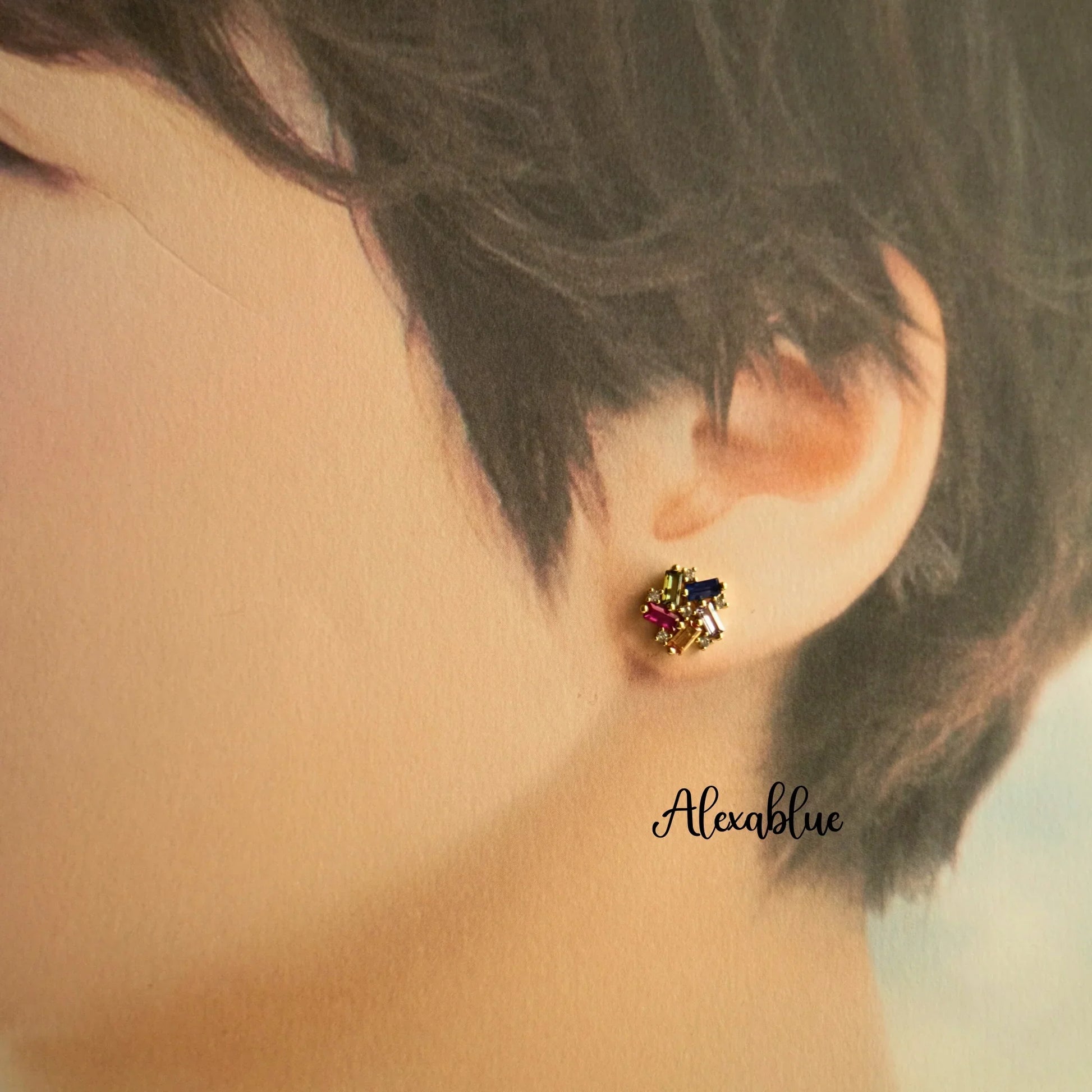 Gold stud earring with colorful natural stones worn on ear, elegant jewelry design