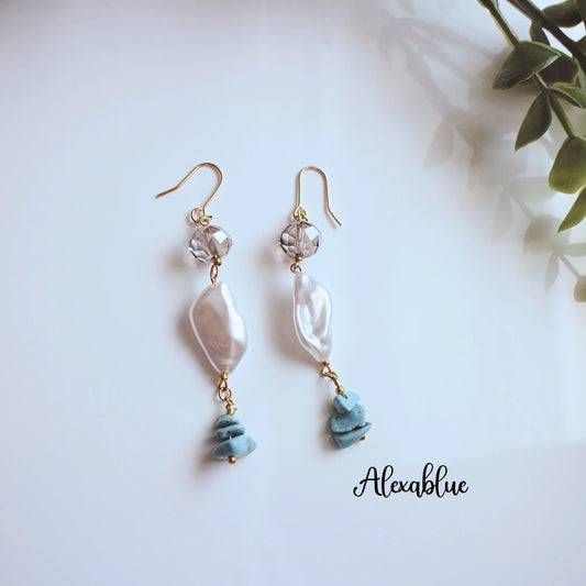 Natural stone and pearl dangle earrings with gold hooks on white background