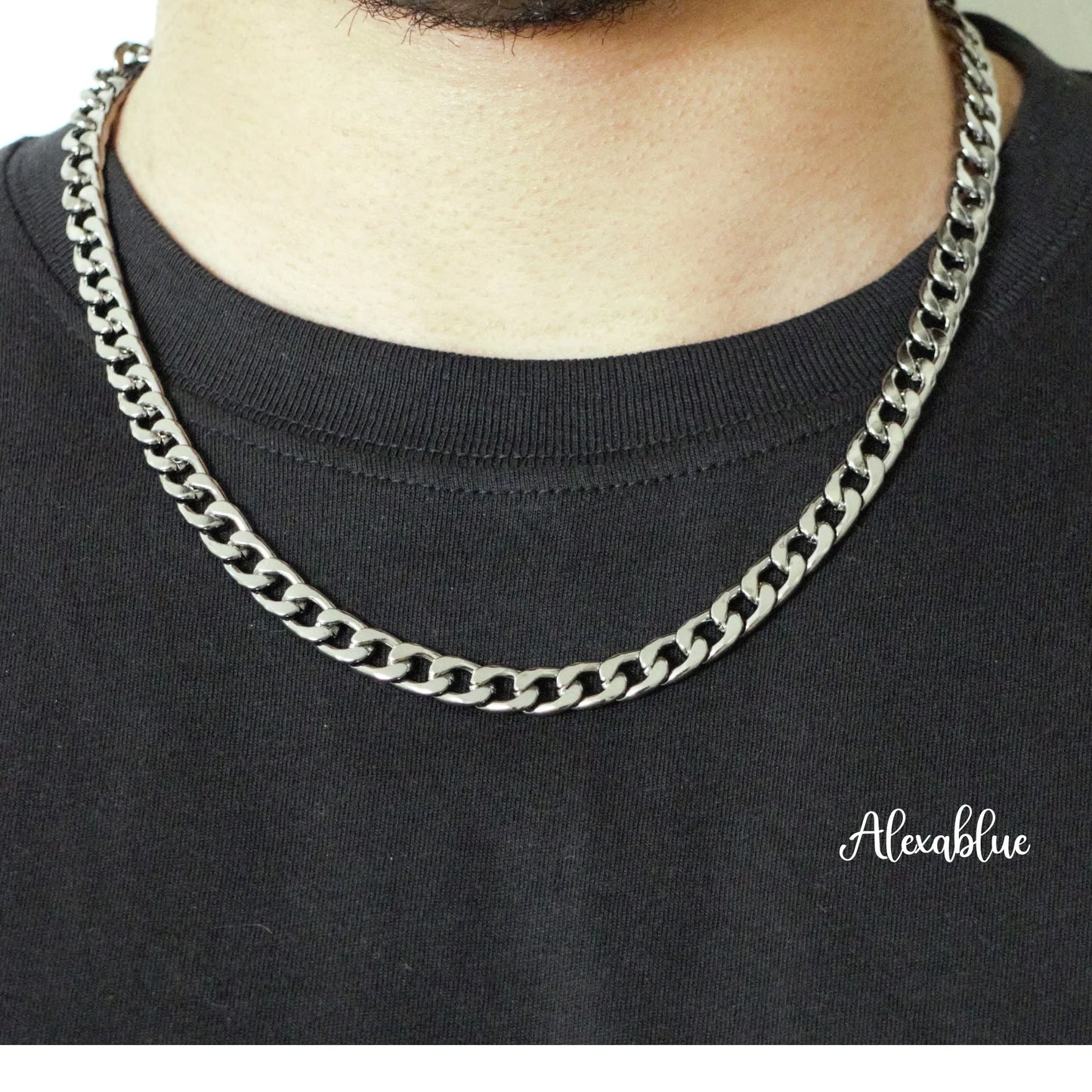 Silver curb chain necklace on a person wearing a black shirt, modern men's jewelry