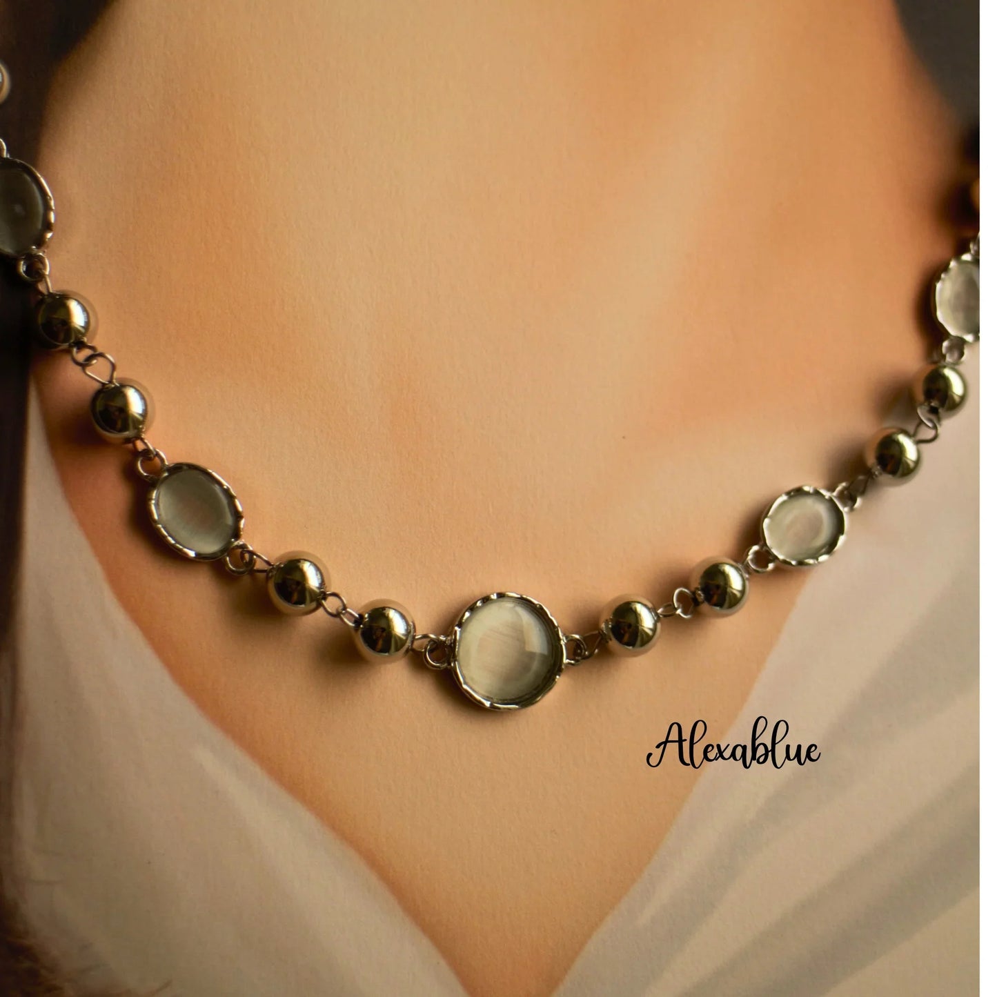 Elegant natural stone necklace with round silver beads and clear gemstones on a neckline