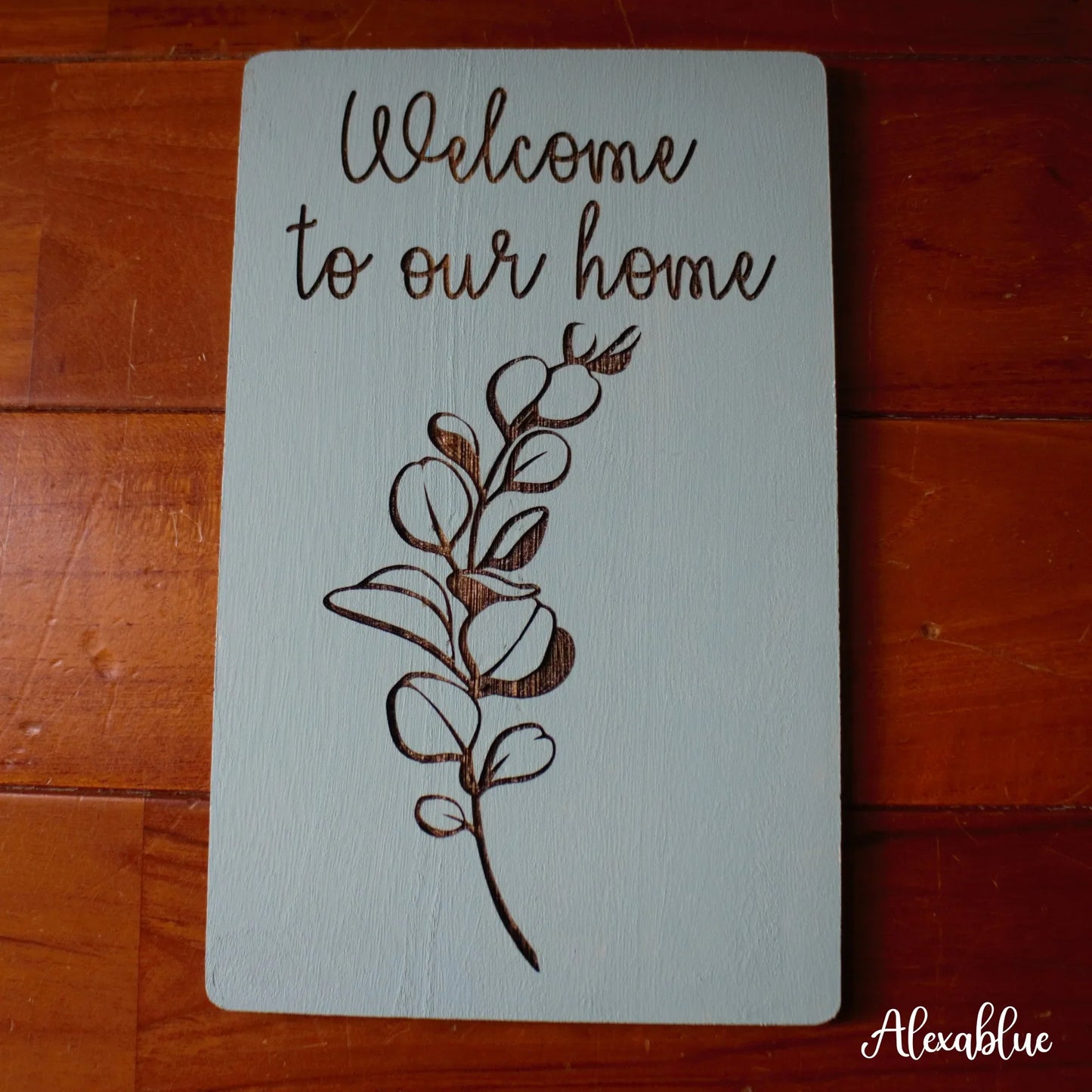Wooden welcome sign with floral design and 'Welcome to our home' engraved, home decor accent